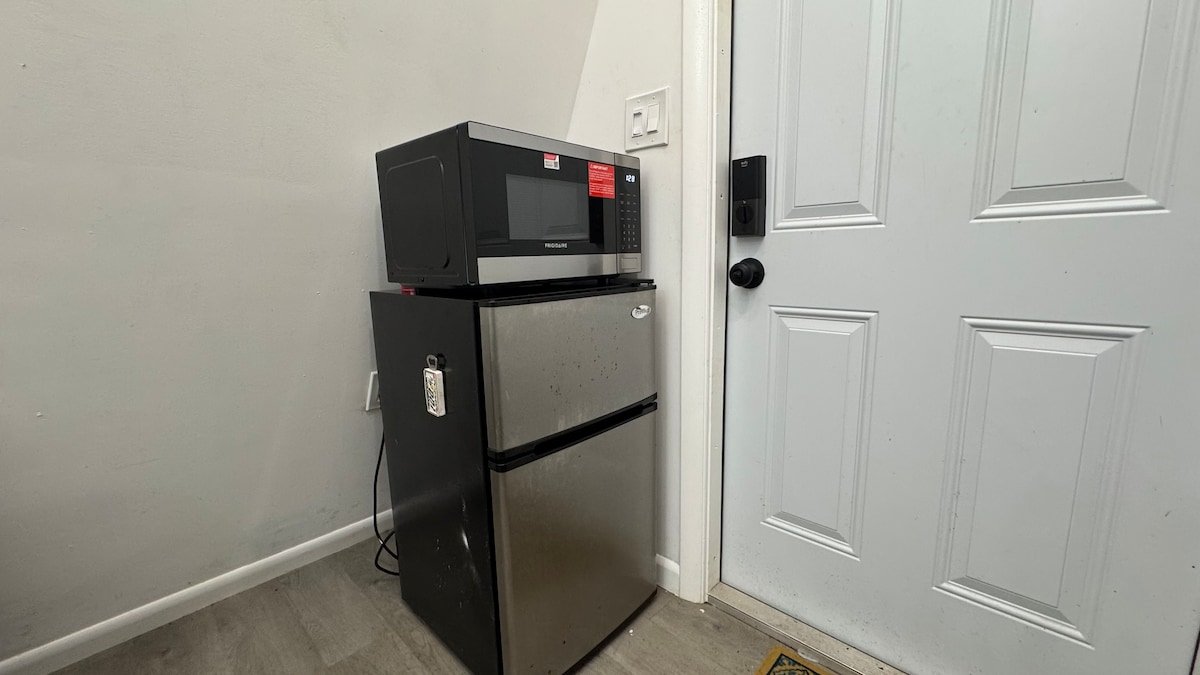 Mini fridge and microwave by the loft door