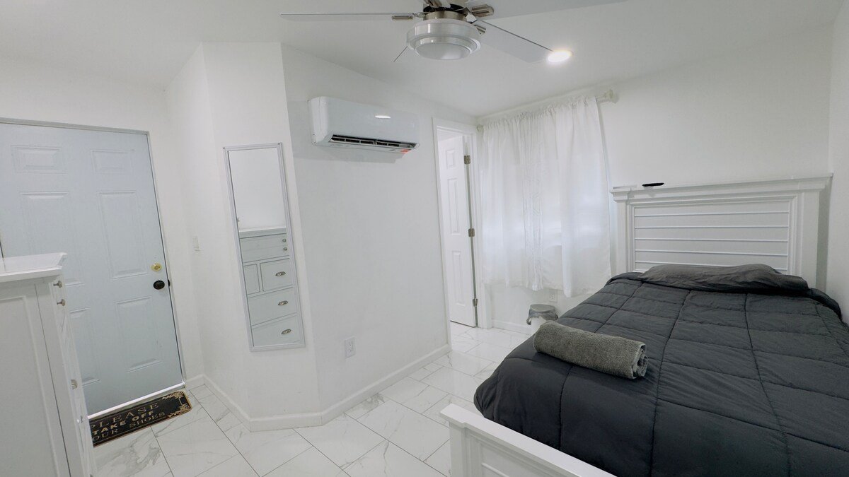 Private Studio Room with bed, ceiling fan and split AC unit