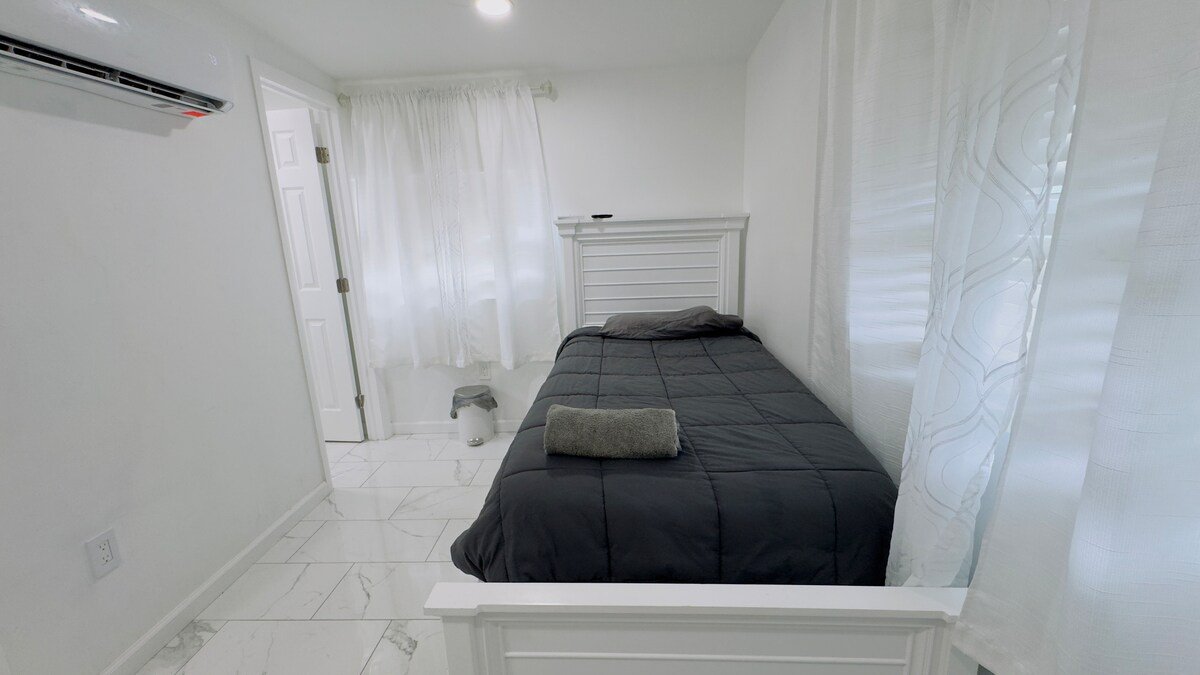 Studio room layout with bed and TV