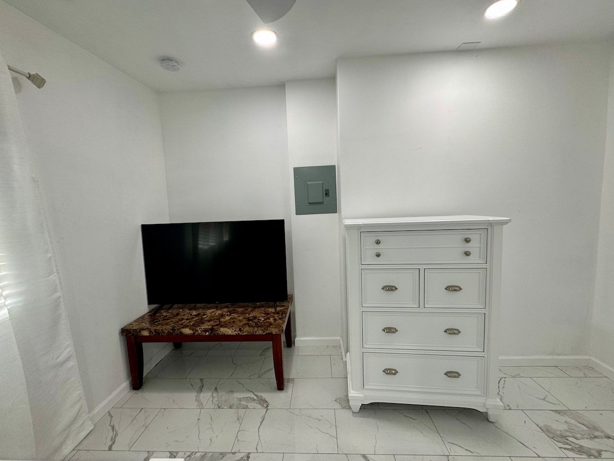 TV, dresser and recessed lighting in the studio