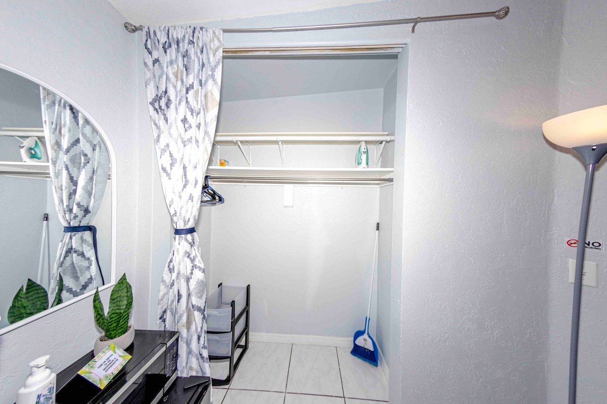 Room West closet with hanging rod and storage