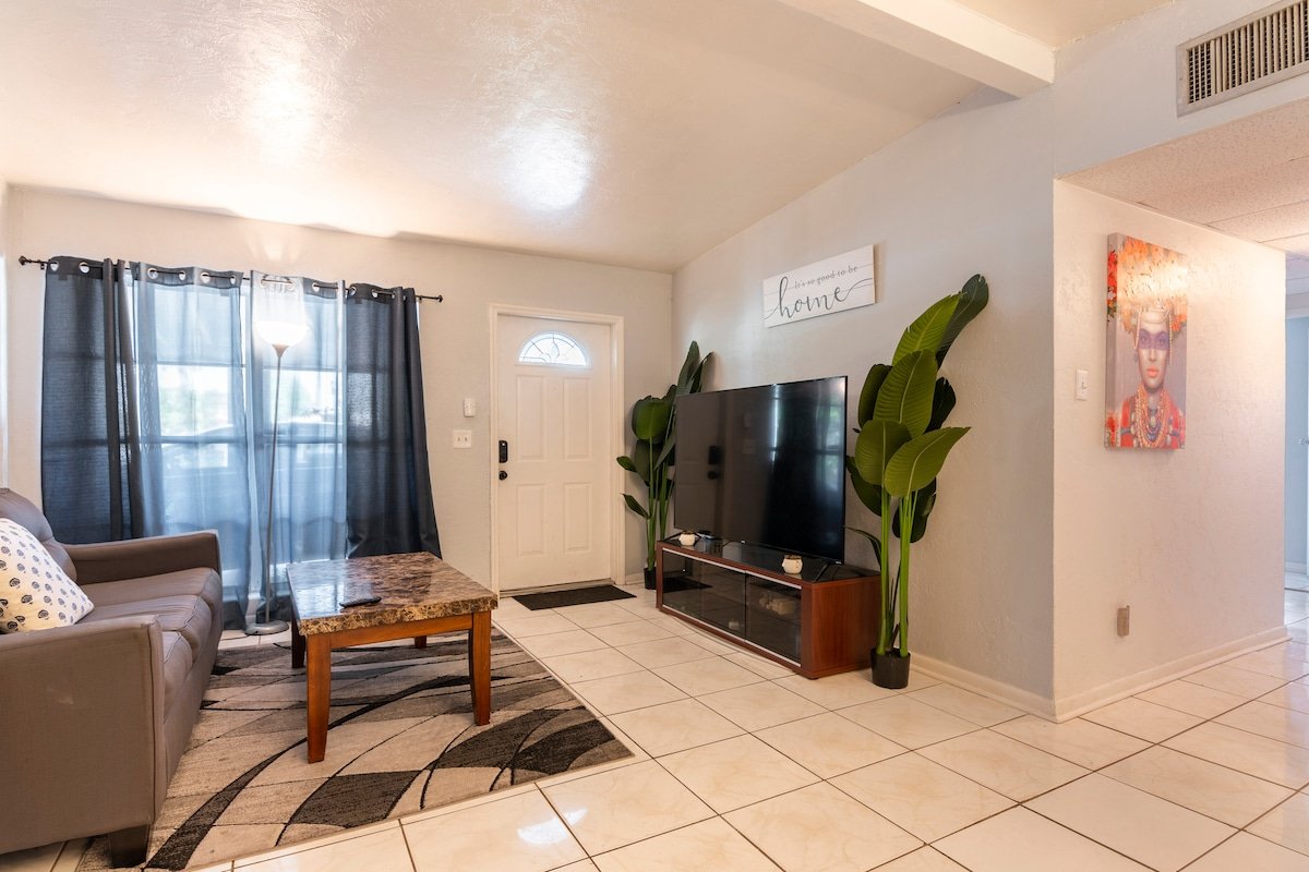 Shared living room with TV and plants