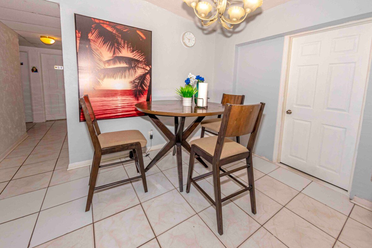 Dining table with four chairs and palm painting