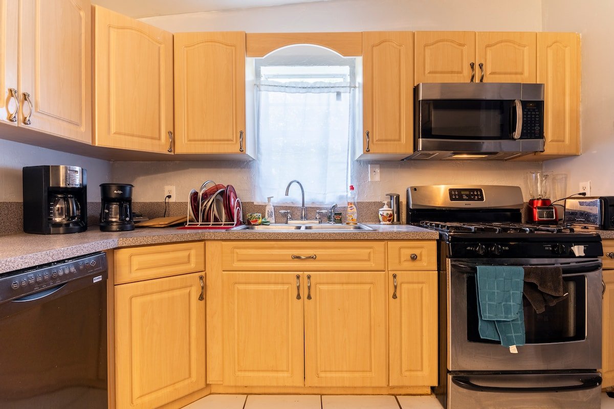Kitchen with gas range, microwave and coffee maker